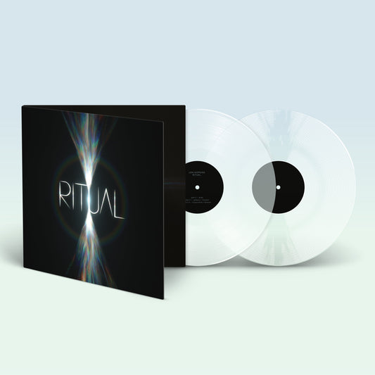 Open gatefold vinyl record sleeve with two clear discs on a light background.
