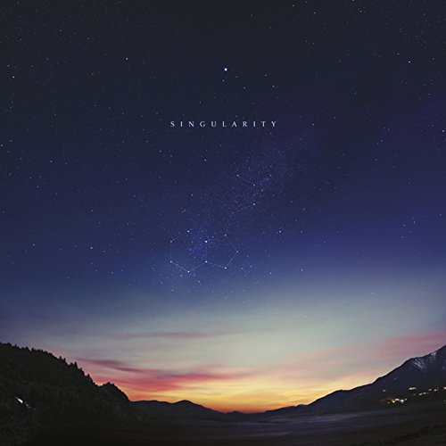 Album cover showing a starry night sky above a mountain landscape at sunset.