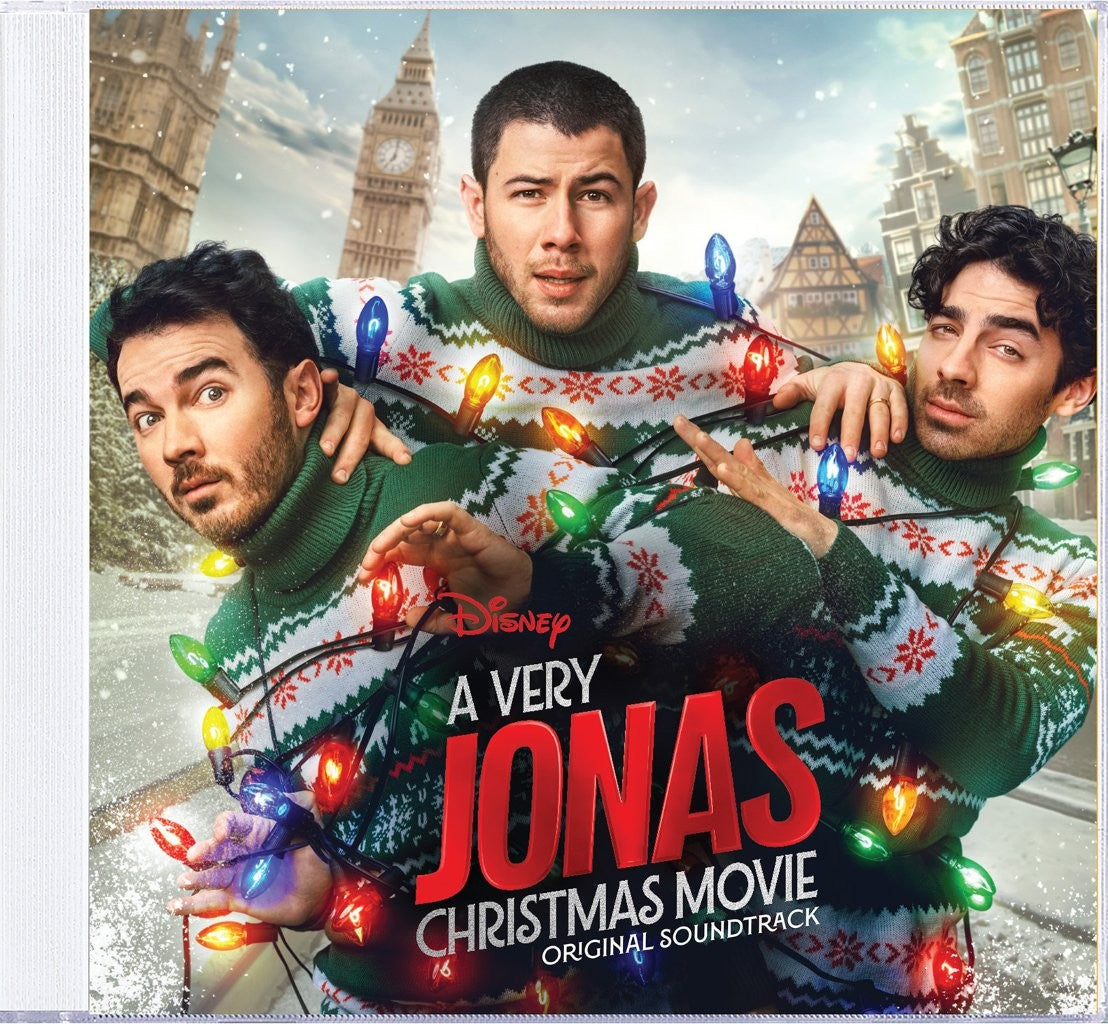 Jonas Brothers in Christmas sweaters, with Big Ben in the background.