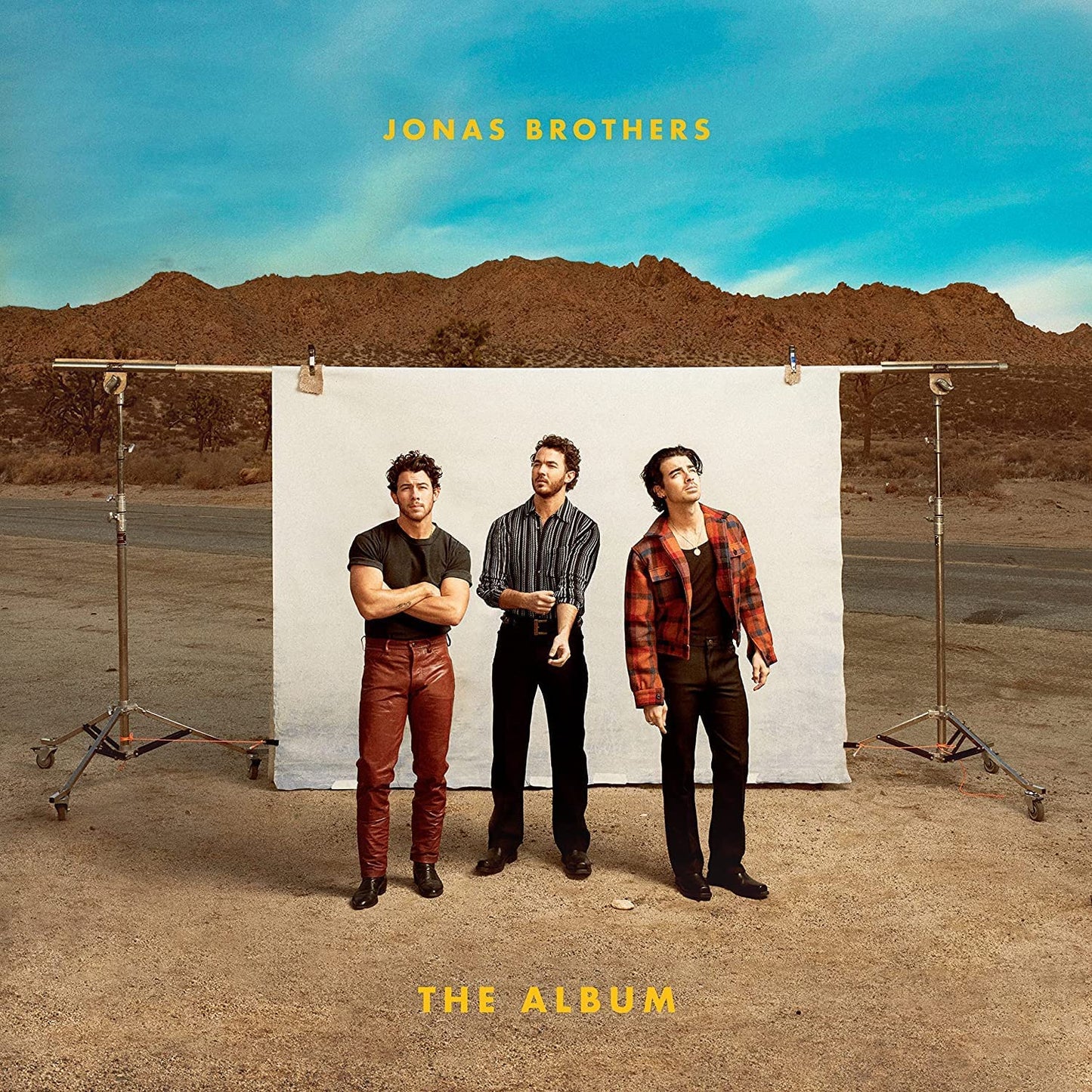 Jonas Brothers album cover featuring the band standing in a desert landscape.