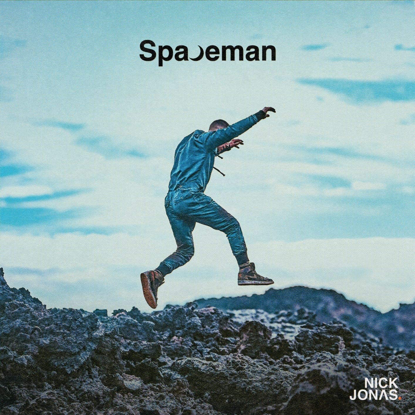 CD cover: man in blue suit leaping against a rocky, blue sky.