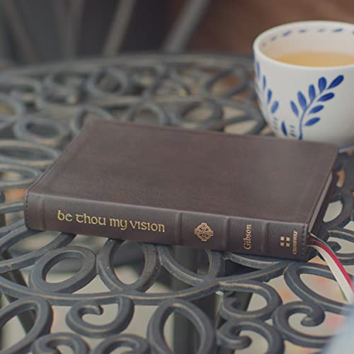 Brown leather book, “Be Thou My Vision,” rests on a metal table.