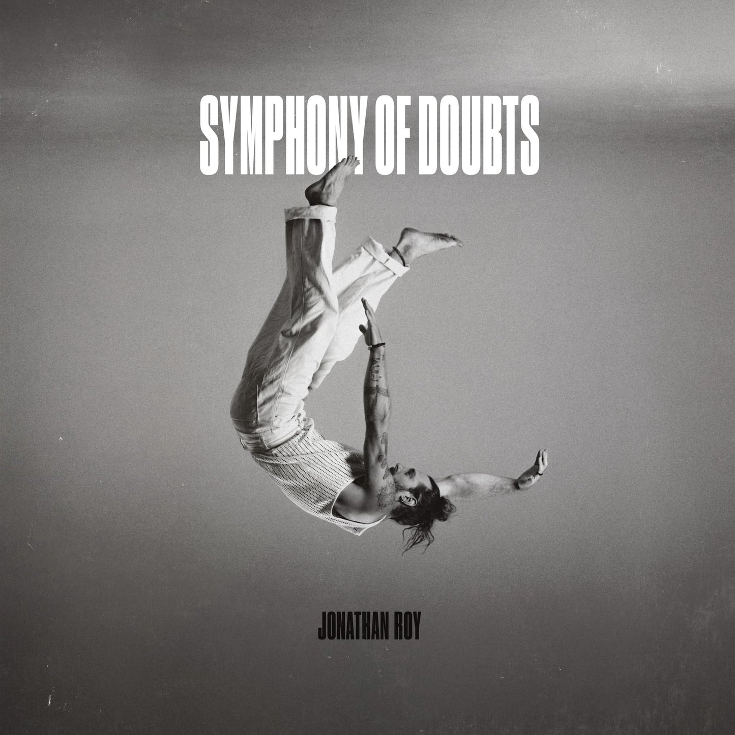 Album cover: black and white image of a man falling upside down.