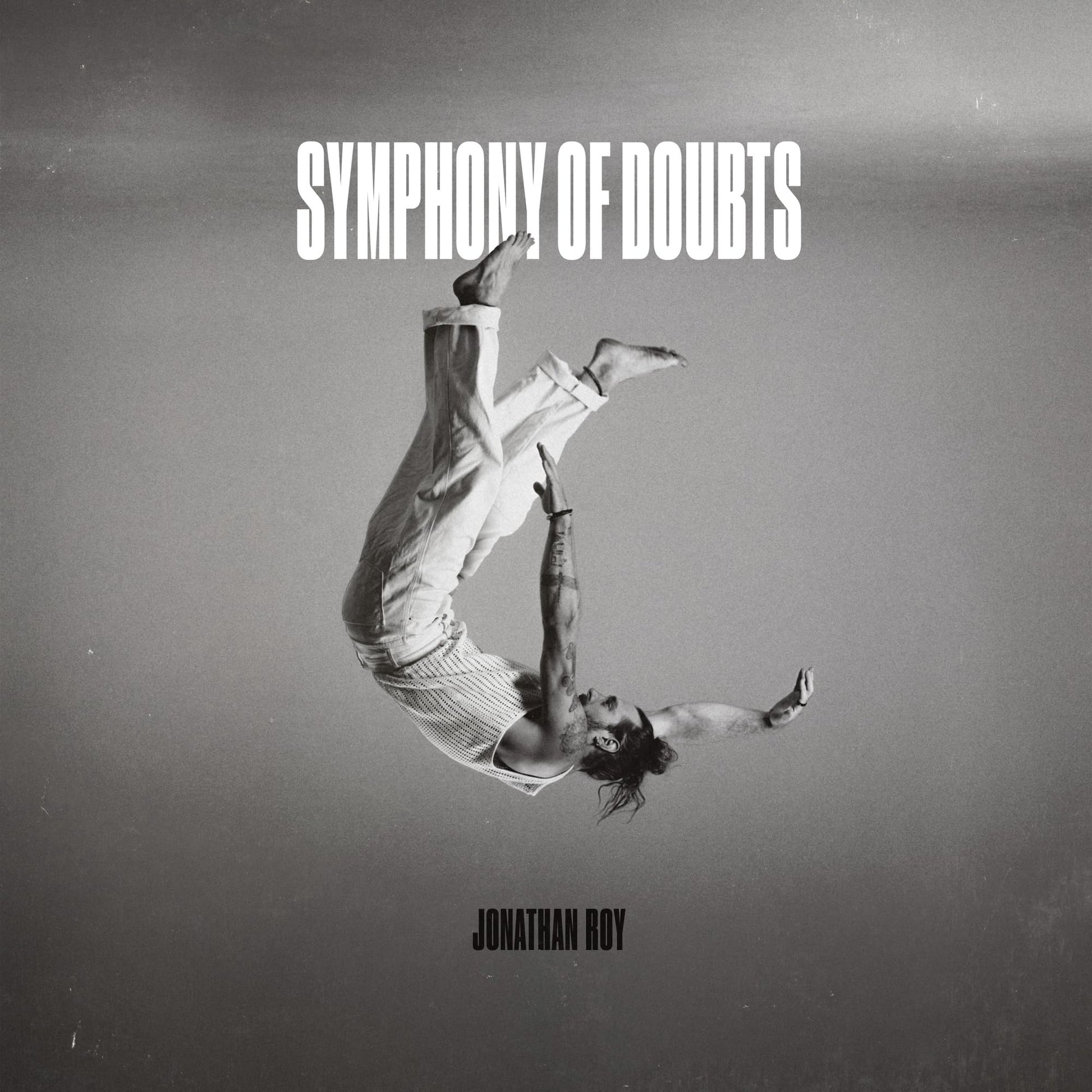 Album cover: black and white image of a man falling upside down.
