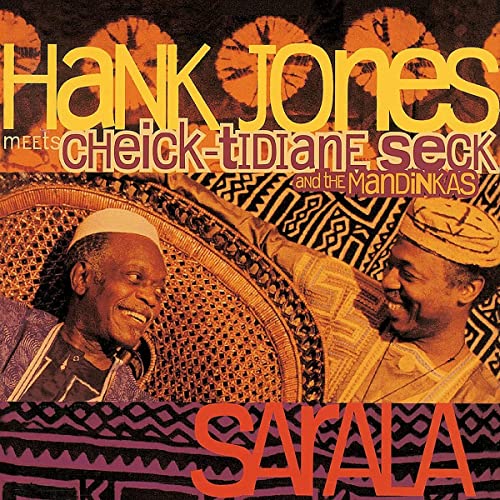Album cover featuring two musicians and patterned textiles, titled "Sarala.
