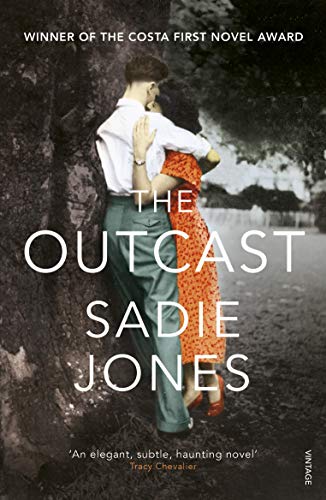 A man and woman embrace against a dark tree in this book cover.