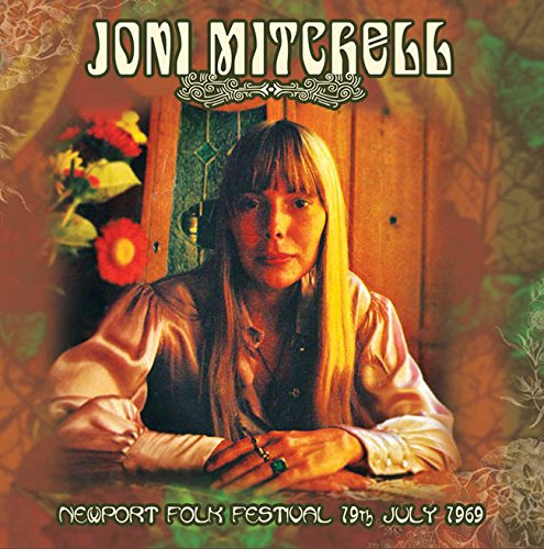 Joni Mitchell album cover, portrait with floral and wooden door backdrop.