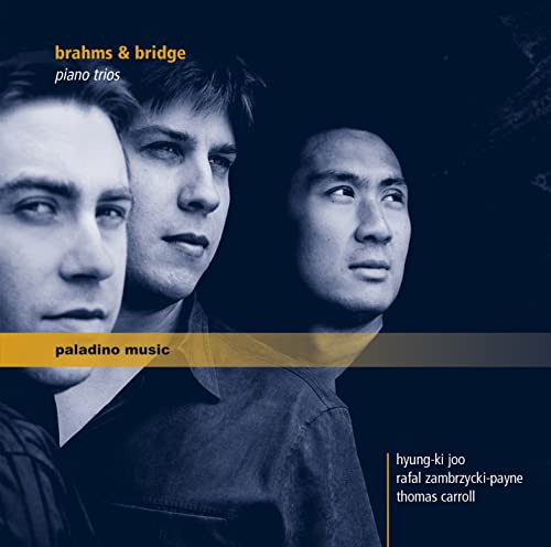 CD cover featuring portraits of three musicians, dark blue background.