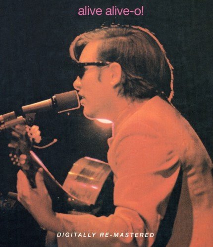 "CD cover with a man singing into a microphone, playing guitar, sepia-toned."