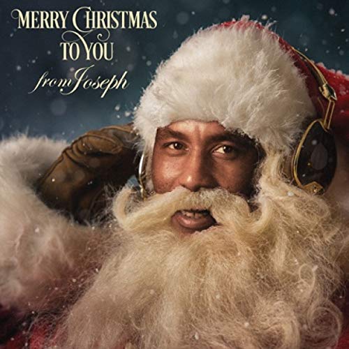 A man dressed as Santa Claus wearing headphones against a snowy background.