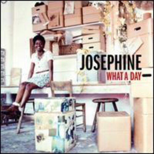Vinyl album cover featuring a woman sitting on a table surrounded by boxes.