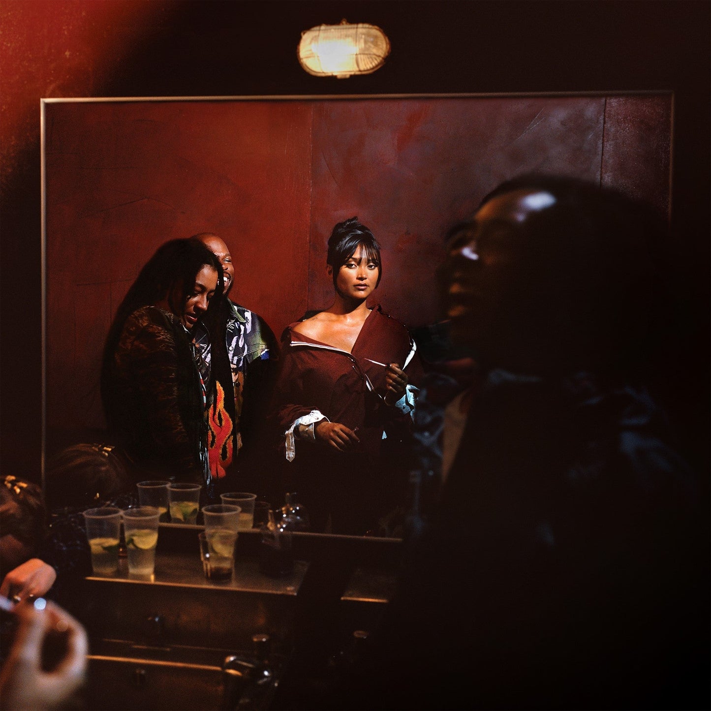Joy Crookes album cover: a dimly lit bar scene with people.