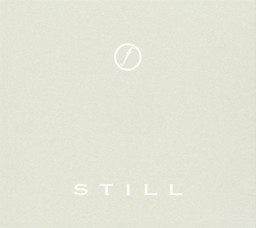 "Album cover with 'STILL' text and a logo on beige background."