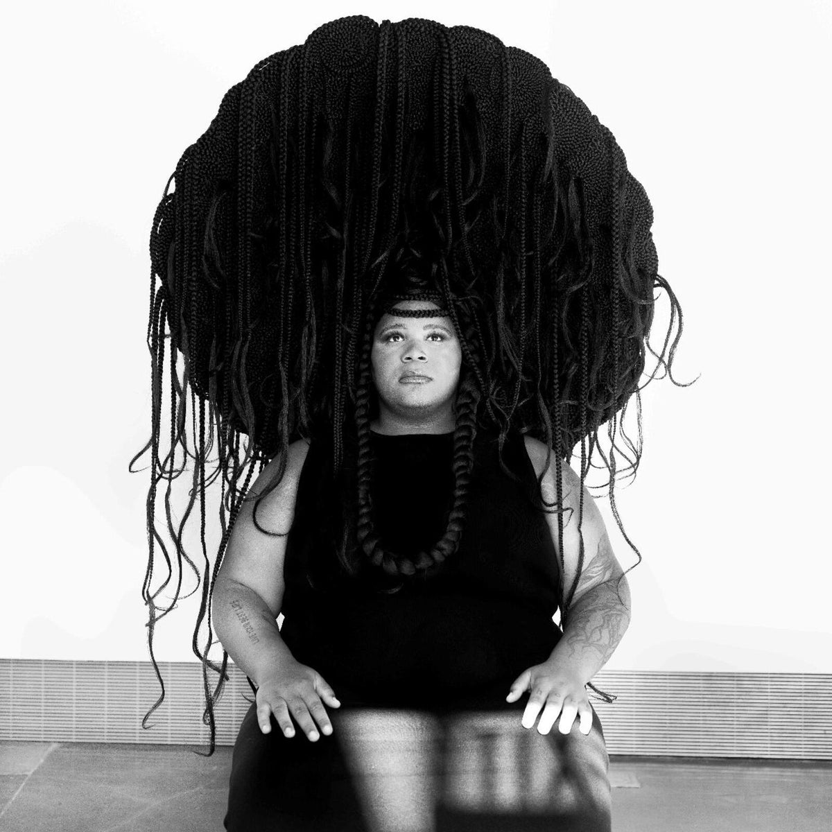 Black and white portrait of Joy Guidry with long, braided hair.