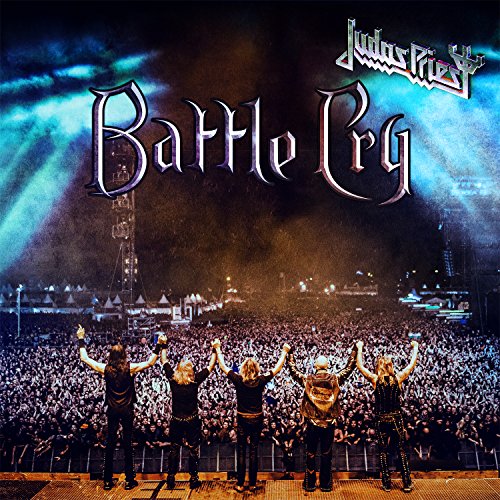 Judas Priest band members on stage facing a large crowd at a concert.