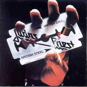 A hand holds a razor blade printed with the Judas Priest logo and album title.