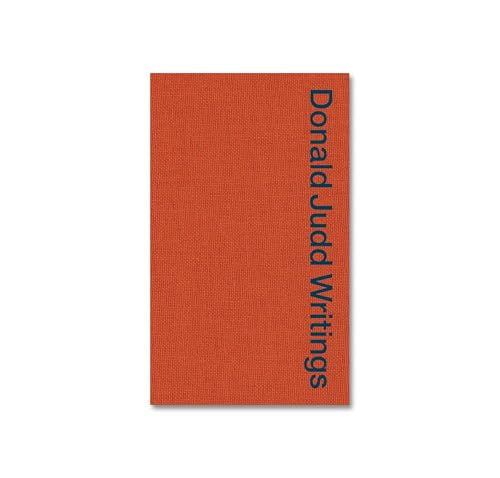 Red book cover with vertical dark text: "Donald Judd Writings".