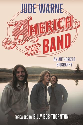 Book cover for "America, the Band" biography featuring three men and landscape.