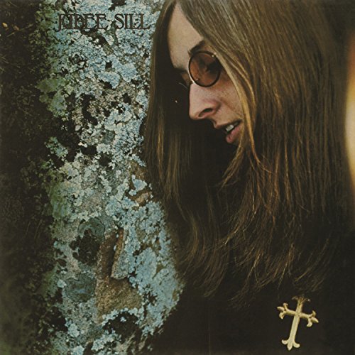 Vinyl album cover featuring a woman with long hair and a cross necklace.