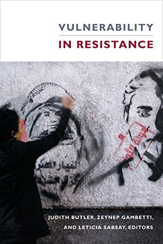 Book cover showing a person painting black and red graffiti portraits on a wall.