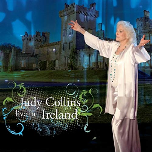Judy Collins performing on stage with an Irish castle backdrop and decorative floral text.