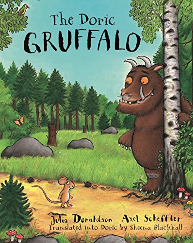The Gruffalo stands behind a tree as a small mouse walks on a path.
