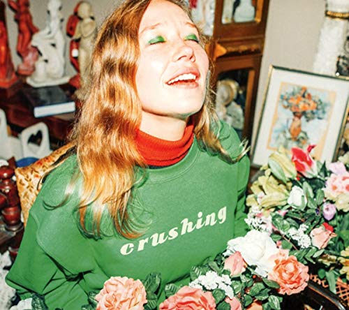Julia Jacklin album cover: woman with eyes closed, flowers, green sweater.