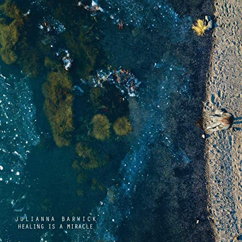 Album cover for Julianna Barwick’s “Healing Is A Miracle,” aerial beach view.