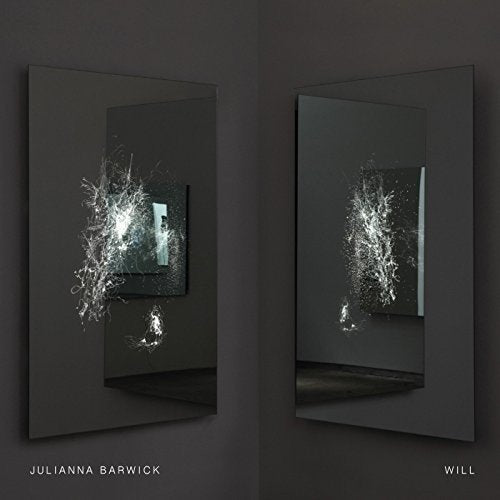 "Vinyl album cover with shattered mirror images on a dark background."
