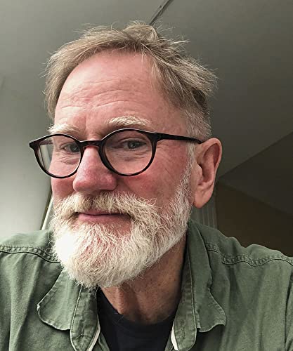 Middle-aged man with a gray beard and glasses wearing a green shirt.