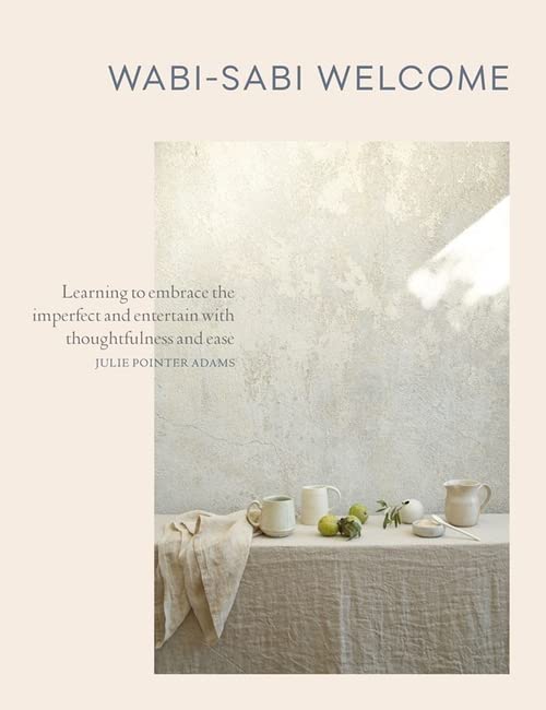 Book cover with textured background, white ceramics, and linen cloth.
