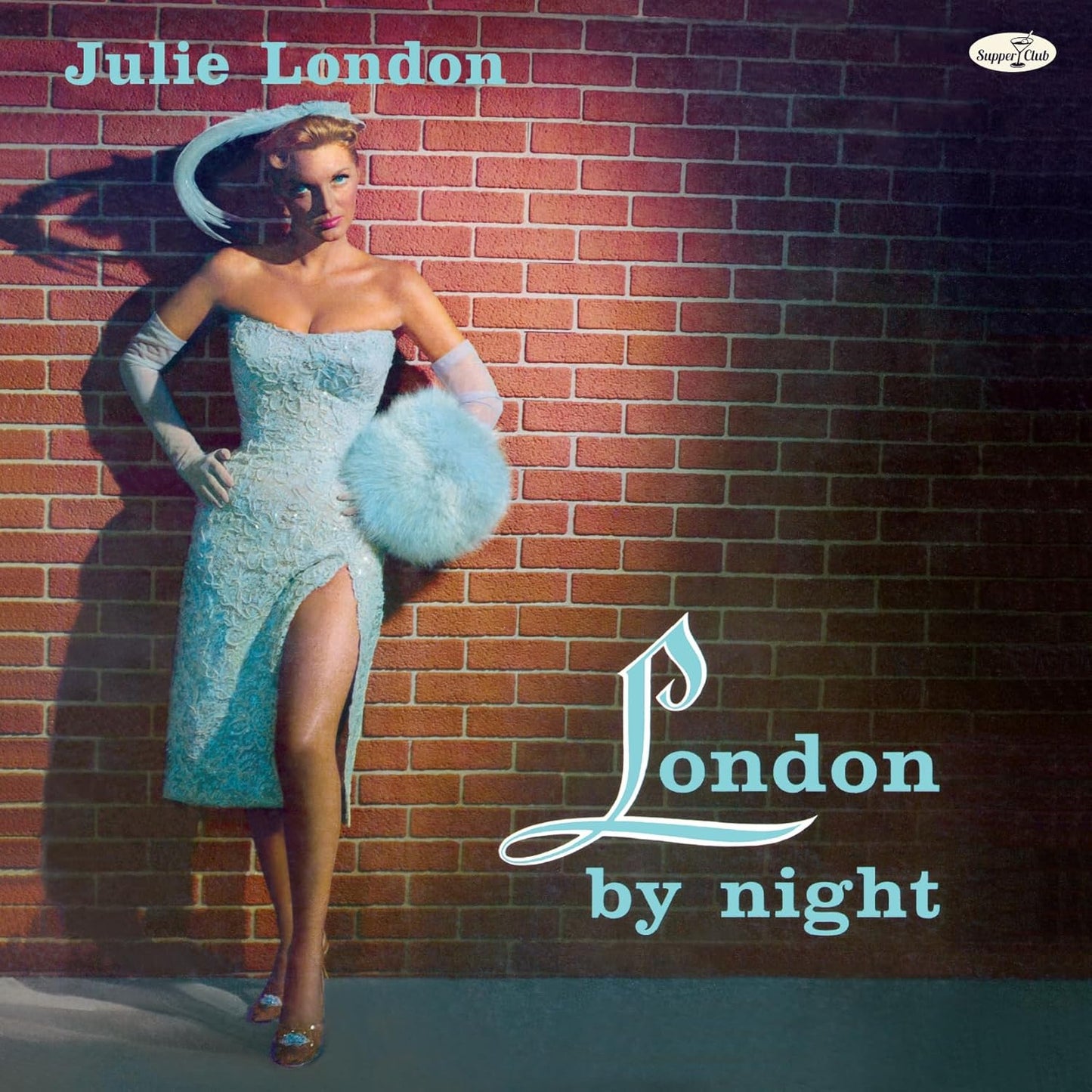 Julie London album cover: woman in blue dress against a brick wall.