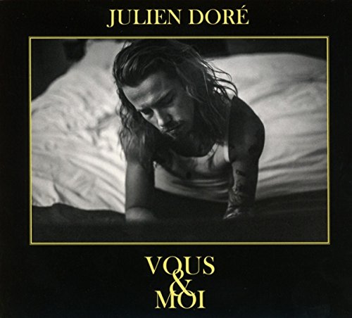 Julien Doré album cover: black and white portrait of a man in bed.
