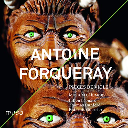 CD cover featuring a carved wooden mask with glowing green eyes.