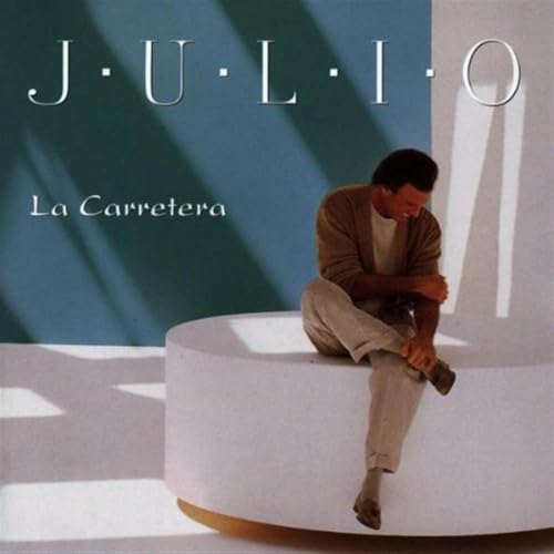 Julio Iglesias album cover: man sitting on a white cylinder.