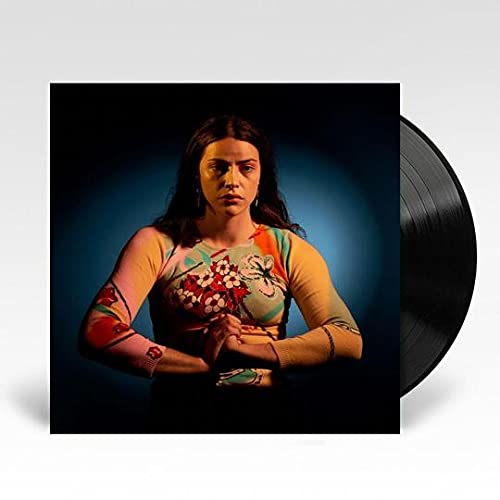 Vinyl record with cover art featuring a woman in a floral top.