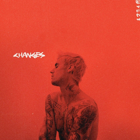 "Album cover with Justin Bieber, tattoos visible, against a red background, 'CHANGES' written."