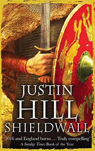 Warrior with shield and sword, book cover for "Shieldwall" by Justin Hill.