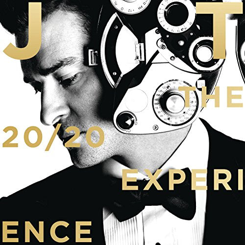 Black and white portrait of Justin Timberlake wearing a tuxedo and an optometrist phoropter.