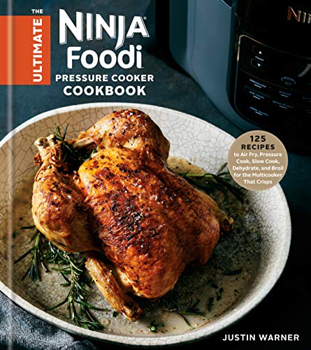 "Cookbook cover featuring roasted chicken on a plate with a Ninja Foodi appliance."