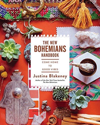 Book cover surrounded by succulents, crystals, tassels, and decorative objects on orange background.