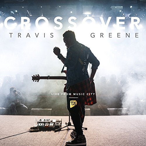 Travis Greene album cover, musician on stage with guitar, smoky background.