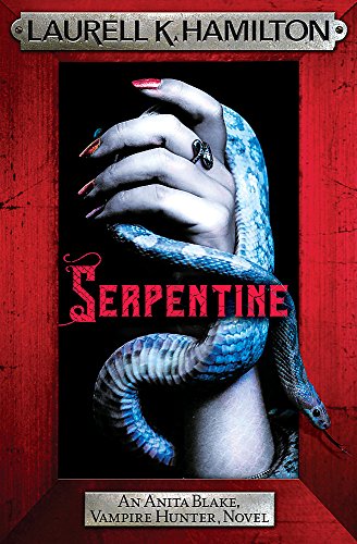 A hand with painted nails holds a blue snake against a black background.