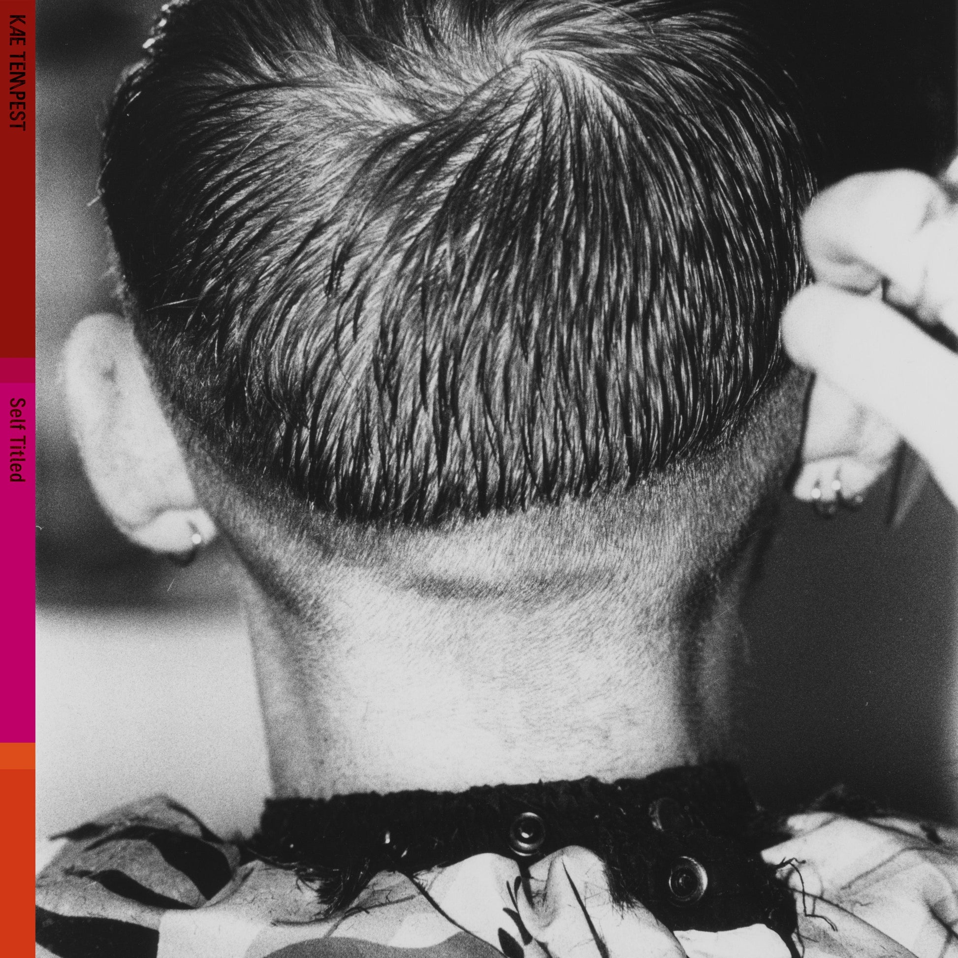Black and white photo of the back of a person’s head and neck.