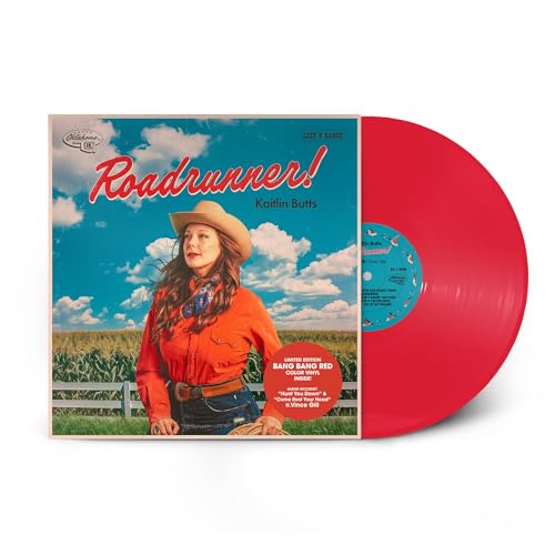 Kaitlin Butts wearing a cowboy hat in front of a field with red vinyl.