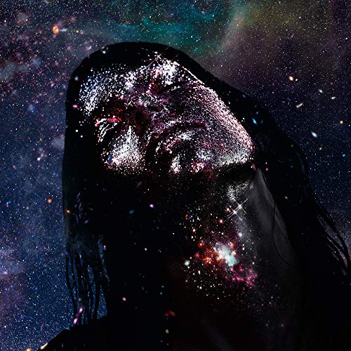 Close-up of a person’s face covered in glitter against a starry background.