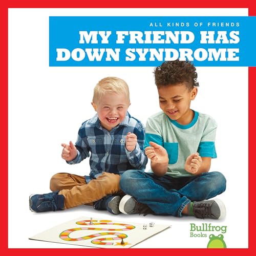 Two young boys sit on the floor playing a board game together.