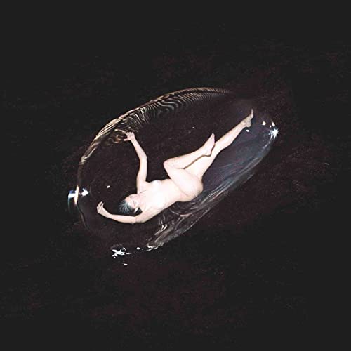 Nude figure floating within a dark, translucent, oval shape.