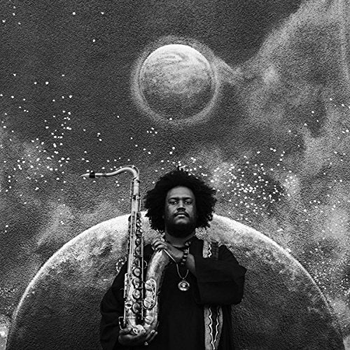 Kamasi Washington album cover: man with saxophone against a cosmic backdrop.