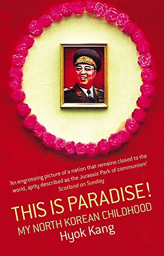 Book cover: portrait of Kim Il-sung framed by pink flowers, red background.